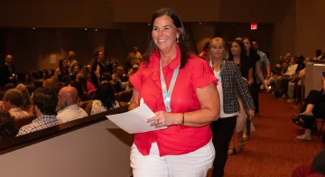 Robin Faulkner walks at the nurse pinning ceremony