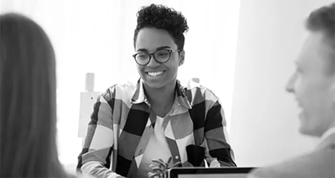 Young woman converses with colleagues.