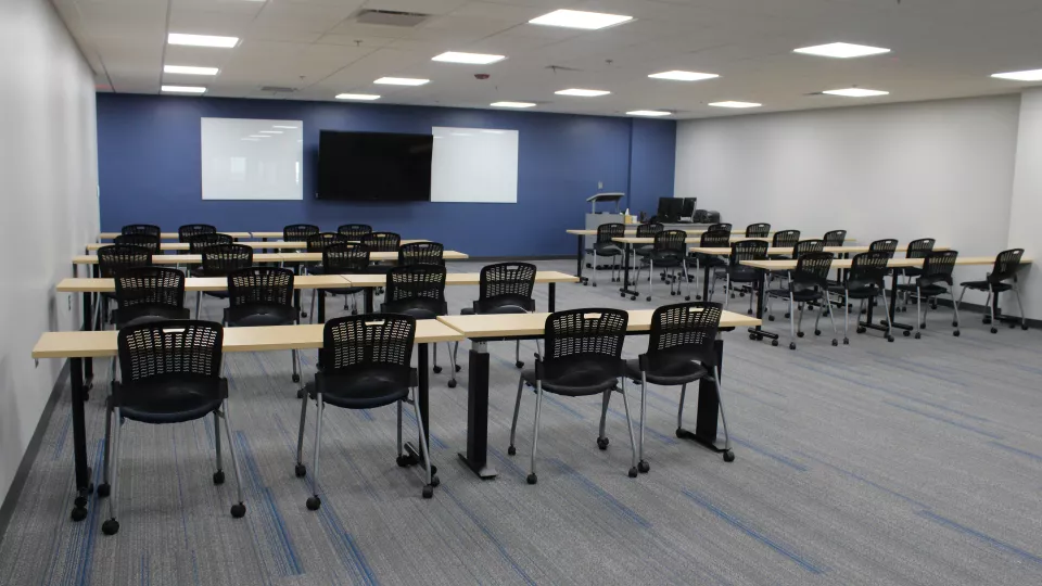 An upgraded Radiology Lab classroom with tables and chairs.