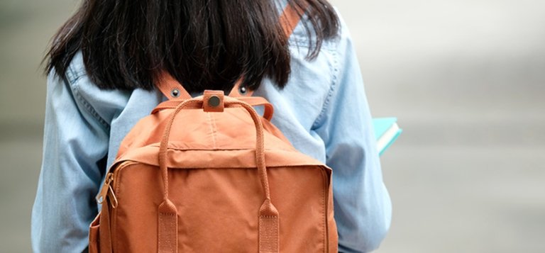 TCC female student carrying a backpack strolls to class.