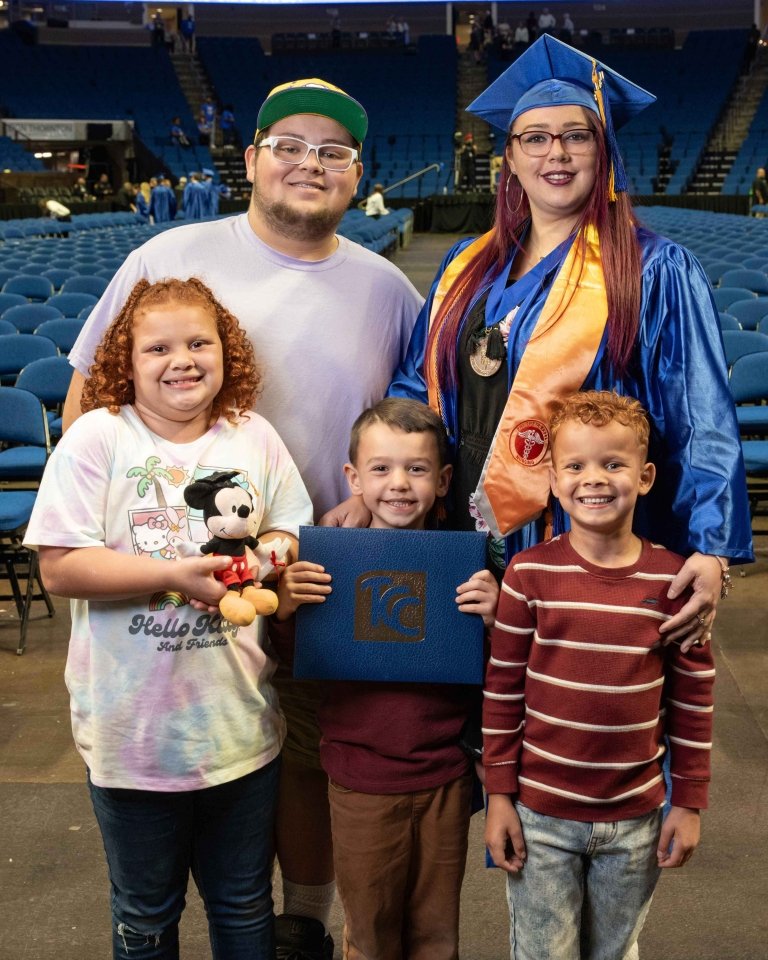 Shenoah poses with her four children after the commencement ceremony